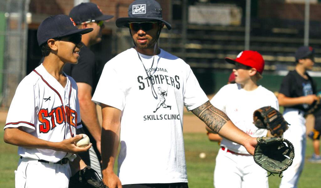 Bill Hoban/Index-TribuneA lesson from a proStomper leftfielder Mark Hurley gives some advice to XX XXXX during the Stompers skills camp for kids last week. Between a dozen and 15 youngsters took part in the camp.