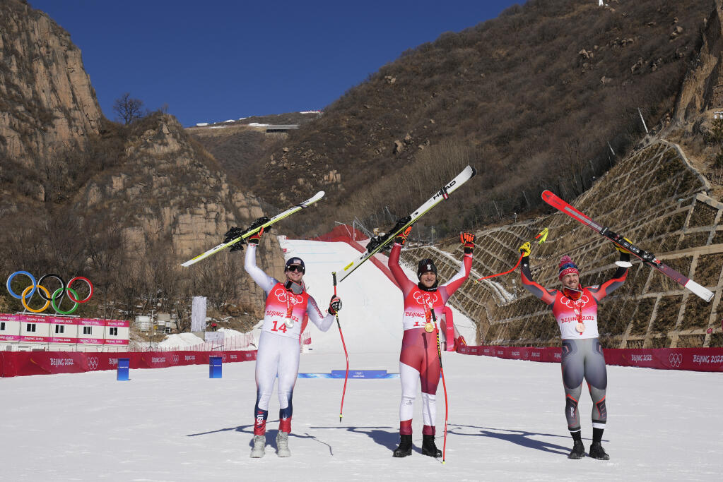 From left, Ryan Cochran-Siegle of the United States, silver, Matthias Mayer of Austria, gold, and Aleksander Aamodt Kilde of Norway, bronze, celebrate during the medal ceremony for the men's super-G at the 2022 Winter Olympics, Tuesday, Feb. 8, 2022, in the Yanqing district of Beijing. (AP Photo/Luca Bruno)