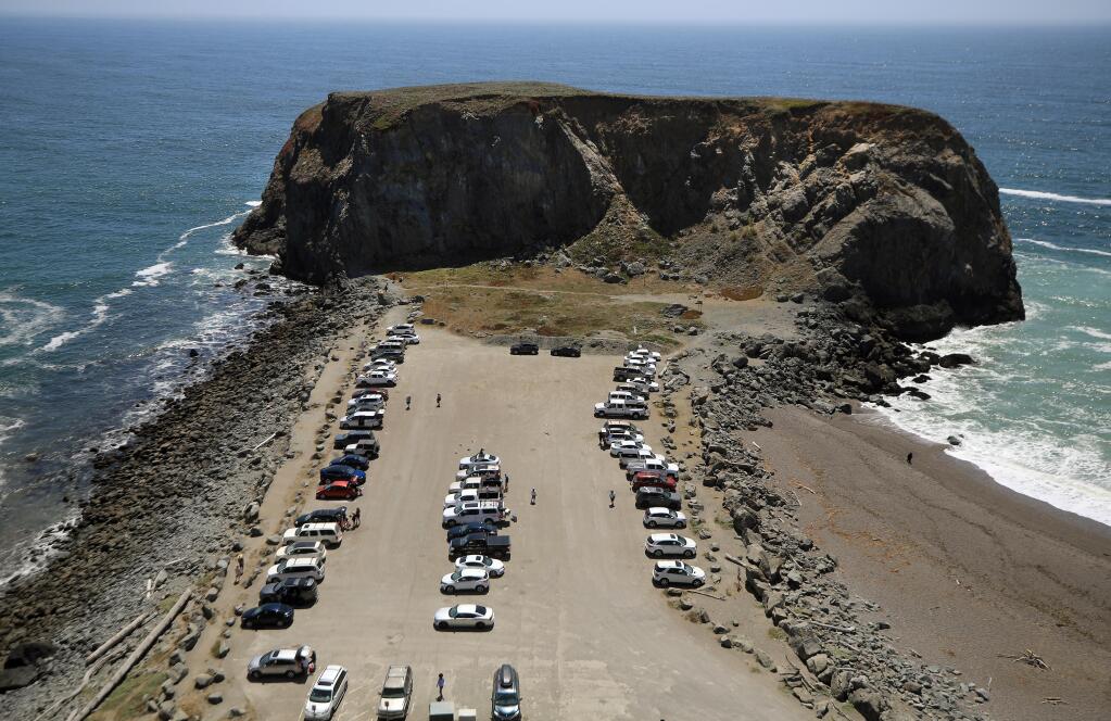 The parking lot at Goat Rock Beach in Jenner on the Sonoma County Coast is partly full, Wednesday, July 1, 2020. The parking lots and pullouts along the Sonoma Coast state beaches will be closed to visitors for the Fourth of July holiday due to the spike of coronavirus infections. However, the beaches will remain open. (Kent Porter / The Press Democrat)