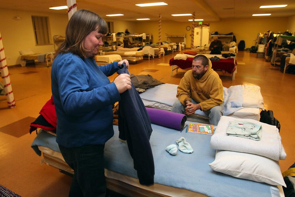 Misty Doig and Ron George fold clothes at the Samuel L. Jones Hall Shelter, a 120-bed homeless shelter in southwest Santa Rosa, in 2010. (JOHN BURGESS/ PD FILE)