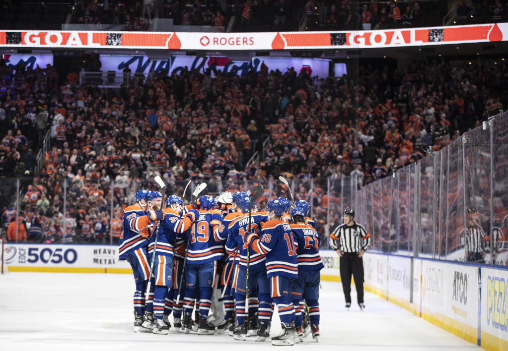Edmonton Oilers celebrate the win over the San Jose Sharks during overtime in an NHL hockey game in Edmonton, Alberta, on Monday March 20, 2023. (Jason Franson/The Canadian Press via AP)
