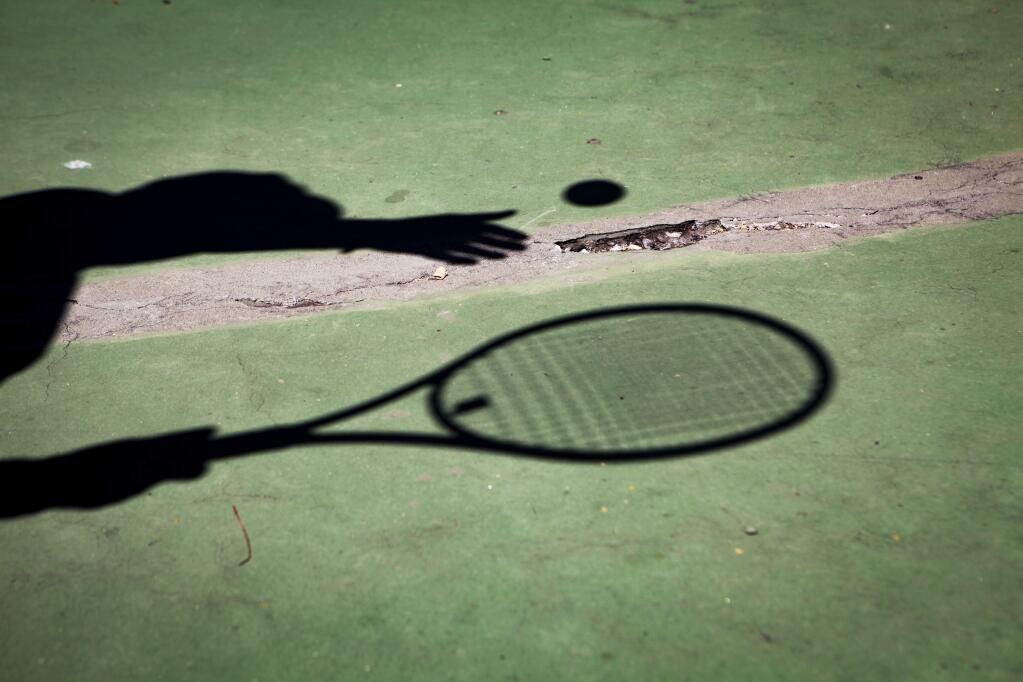 Petaluma, CA, USA. Monday, August 26, 2019._Measure M which was approved by voters last year will provide funding for parks improvements in the county. Many local tennis players and clubs look forward to work on the tennis courts. On a recent morning, men from the 'McNear Tennis Club' played on one of the two courts at McNear Park despite the large cracks in the pavement. (CRISSY PASCUAL/ARGUS-COURIER STAFF)