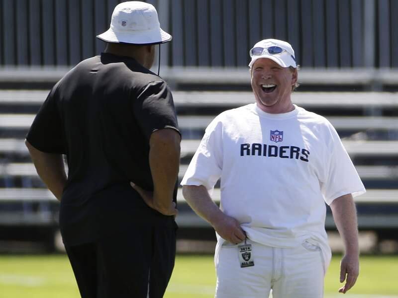 Oakland Raiders owners Mark Davis, right, laughs on the sideline with general manager Reggie McKenzie, left, during their NFL football training camp on Friday, July 25, 2014, in Napa, Calif. (AP Photo)