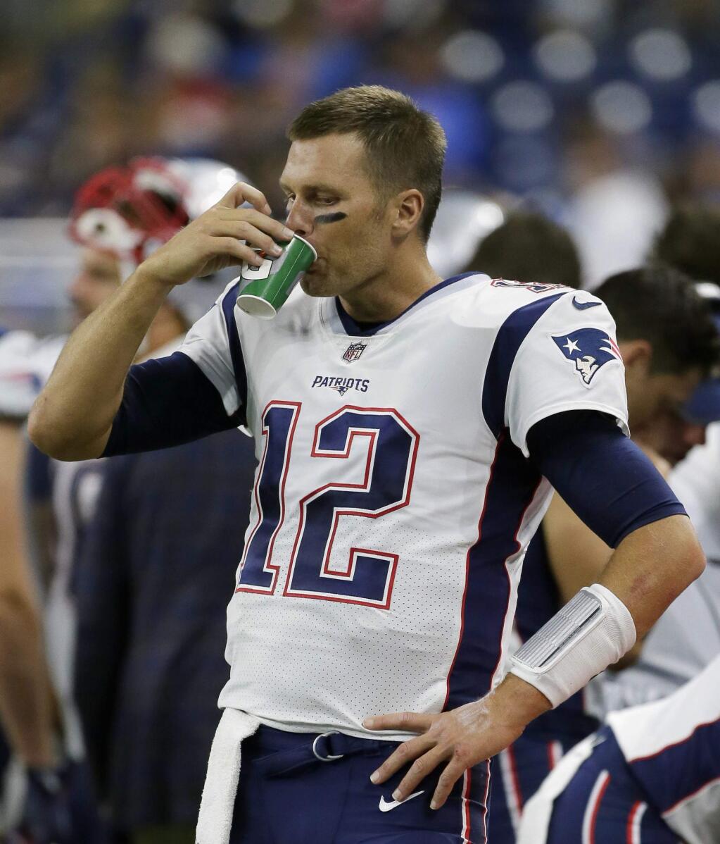 FILE - In this Aug. 25, 2017, file photo, New England Patriots quarterback Tom Brady (12) drinks on the sidelines during the second half of an NFL preseason football game against the Detroit Lions, in Detroit. Brady may not like strawberries, but he has skills when it comes to chugging beer. Appearing Monday, March 12, 2018, on CBS's 'The Late Show with Stephen Colbert,' Brady promoted his book 'The TB12 Method,' in which he writes about diet and athletic performance. That includes abstaining from alcohol. Brady told Colbert he rarely drinks beer. But acknowledged he was a 'pretty good beer chugger back in the day.'(AP Photo/Duane Burleson, File)