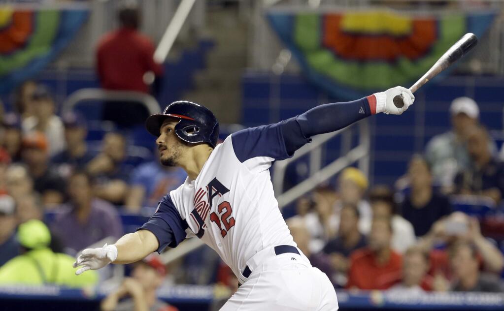 Nolan Arenado, of the United States, follows through on his three-run home run against Canada in the second inning in a first-round game of the World Baseball Classic, Sunday, March 12, 2017, in Miami. Adam Jones and Christian Yelich scored on the home run. (AP Photo/Alan Diaz)