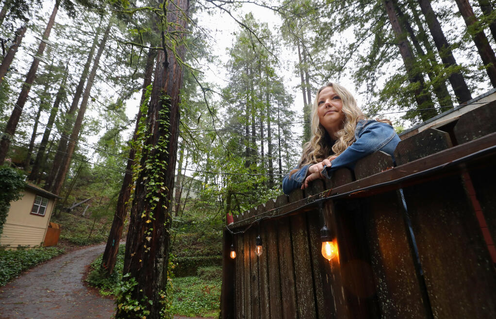 Russian River resident Jenn Otten worries about the trees surrounding her home whenever it rains and the ground becomes saturated.  Photo taken at her home in Rio Nido, Friday, Jan. 6, 2023.  (Christopher Chung/The Press Democrat)
