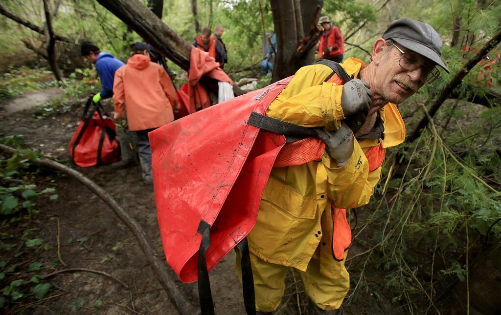 photos by kent porter / the press democratKeary Sorenson of Sebastopol joins Chris Brokate and others to help clean a homeless encampment along the banks of the Russian River in Guerneville.