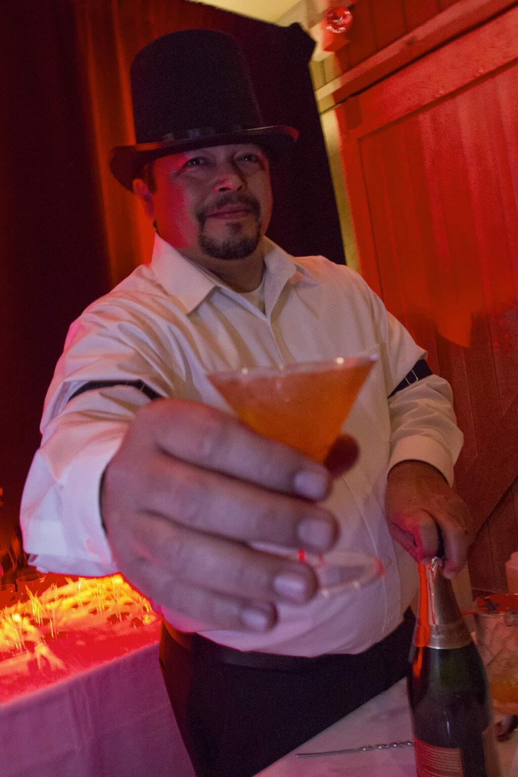 Gerard Stephens offers a martini from Carneros Bistro. Martini Madness took place again this year at MacArthur Place Inn and Spa on Friday, Jan 13. Bartenders from local Sonoma Valley restaurants presented their martini concoctions to a sold-out crowd. (Photo by Robbi Pengelly/Index-Tribune)