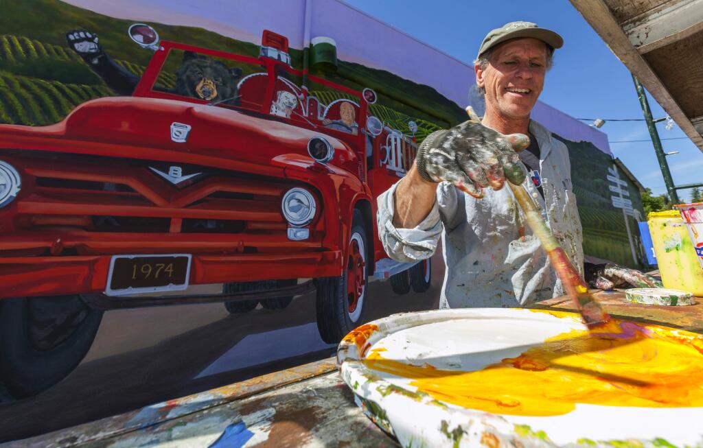 Robbi Pengelly/Index-TribuneSebastopol-based muralist Dave Gordon has been working on a mural on the side of Broadway Market that depicts, among others, the owners of the market, and the late Schell-Vista fire Chief Mitch Mulas driving a fire truck.