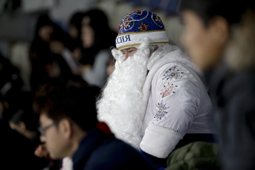 A Russian spectator watches the women's curling matches at the 2018 Winter Olympics in Gangneung, South Korea, Wednesday, Feb. 14, 2018. (AP Photo/Natacha Pisarenko)