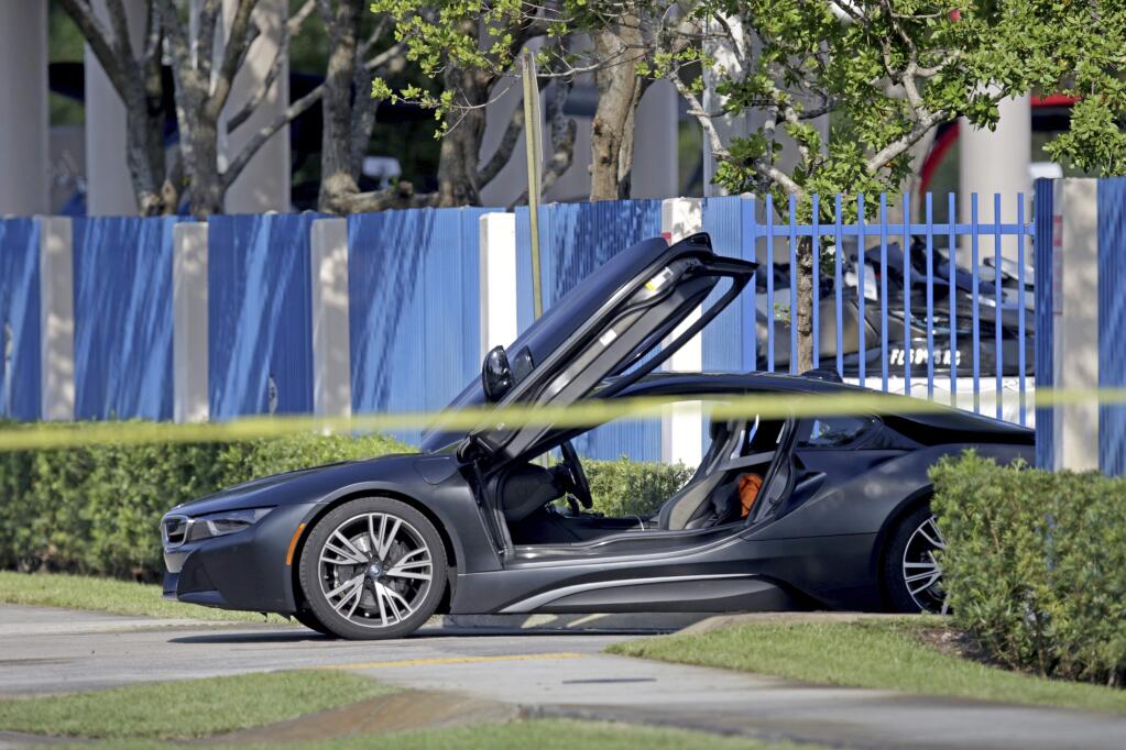 An empty vehicle appears on a street where rapper XXXTentacion was shot on Monday, June 18, 2018, in Deerfield Beach, Fla. The Broward Sheriff's Office says the 20-year-old rising star was pronounced dead Monday evening at a Fort Lauderdale-area hospital. (John McCall/South Florida Sun-Sentinel via AP)
