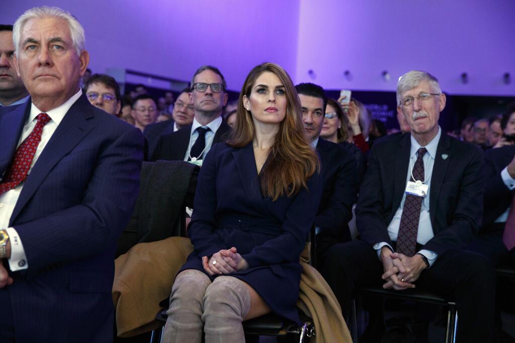 White House Communications Director Hope Hicks, center, and Secretary of State Rex Tillerson, left, listen to President Donald Trump deliver a speech to the World Economic Forum, Friday, Jan. 26, 2018, in Davos. (AP Photo/Evan Vucci)