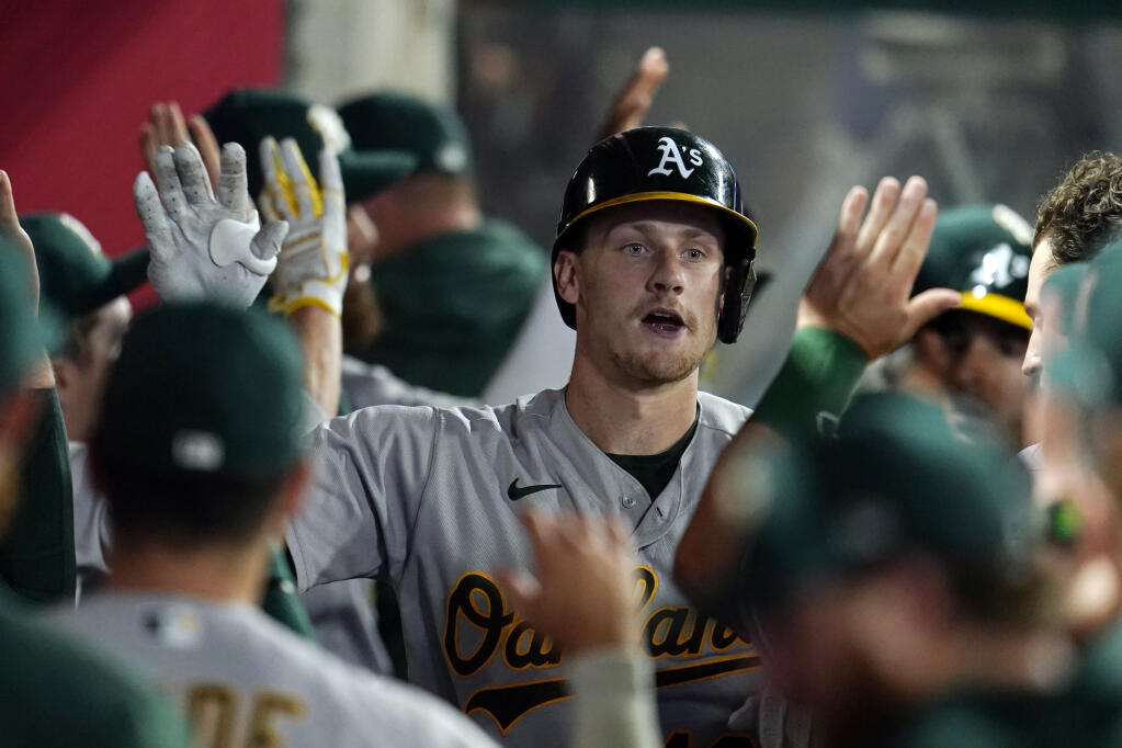 The A’s Sean Murphy, center, is congratulated in the dugout after his two-run home run against the Los Angeles Angels during the sixth inning Wednesday, Aug. 3, 2022, in Anaheim. (AP Photo/Marcio Jose Sanchez)