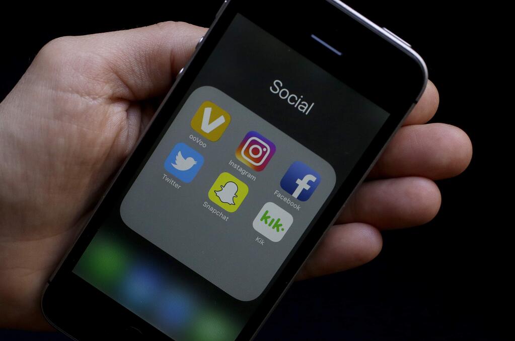 This June 16, 2017 photo shows social media app icons on a smartphone held by an Associated Press reporter in San Francisco. Google yourself. Curate your online photos. And as one private high school advises its students: Don't post anything online you wouldn't want your grandmother to see. AP spoke with experts on the role of social media in the college admissions process. They offered tips for students on what to post - and not post - if you're trying to get into college. (AP Photo/Jeff Chiu)