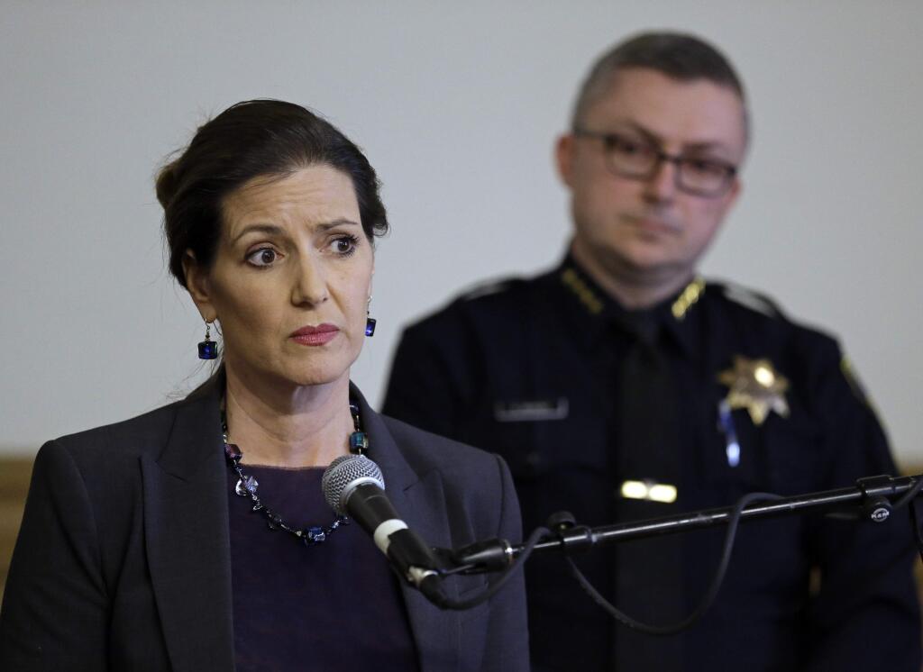 FILE - In this May 13, 2016 file photo, Oakland Mayor Libby Schaaf, left, speaks beside then-Oakland Chief of Police Sean Whent in Oakland, Calif. The teenage daughter of a police dispatcher at the center of a Northern California sexual misconduct scandal involving two dozen officers has filed suit against one of the law enforcement agencies, her attorney announced Friday, Aug. 18, 2017. The 19-year-old filed the federal lawsuit in San Francisco Thursday, Aug. 17, 2017. Whent was forced to resign in June 2016 and the department cycled through two other chiefs in less than a month before the city's top administrator took over management of the police. (AP Photo/Ben Margot, File)