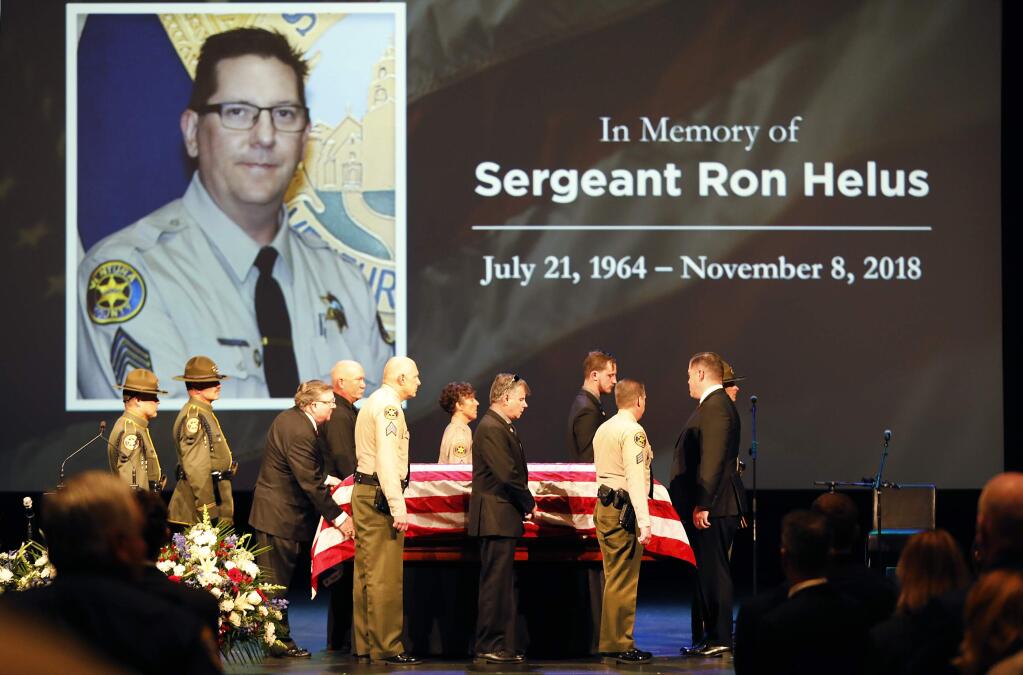 The casket of Ventura County Sheriff Sgt. Ron Helus arrives on stage for a memorial service for Sgt. Helus at Calvary Community Church in Westlake Village, Calif., Thursday, Nov. 15, 2018. (Al Seib /Los Angeles Times via AP, Pool)