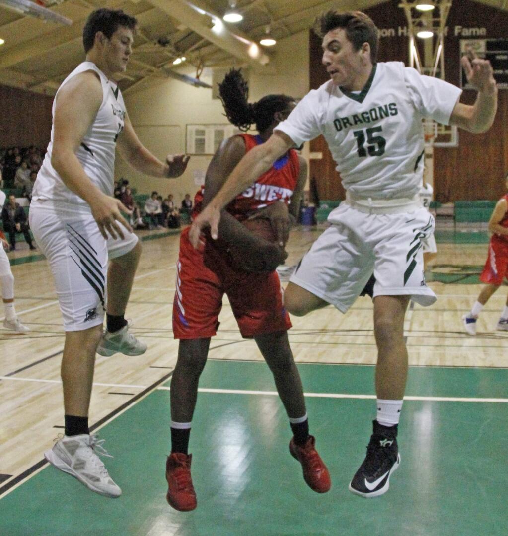 Bill Hoban/Index-TribuneSonoma's Max Gustafson, left, and Dominic Tommasi, right, try to pull down a rebound during a recent game against John Swett. The Dragons opened their non-conference season Tuesday, falling to Terra Linda.
