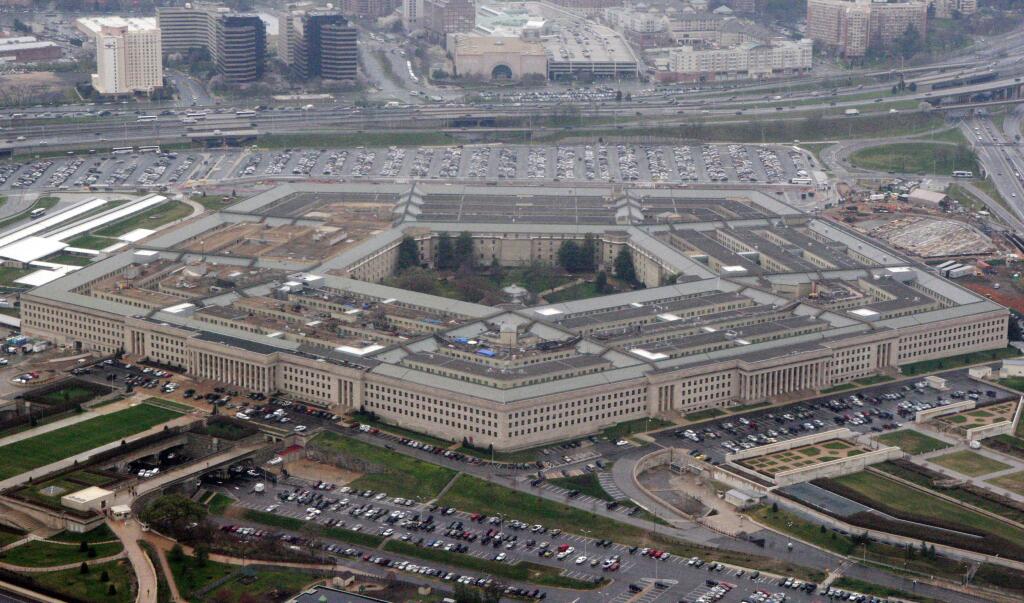 FILE - In this March 27, 2008 file photo, the Pentagon is seen in this aerial view in Washington. A Pentagon official tells The Associated Press that transgender people can enlist in the military beginning Jan. 1, despite President Donald Trump's opposition. The new policy reflects growing legal pressure on the issue. Potential transgender recruits will have to overcome a lengthy and strict set of physical, medical and mental conditions that make it possible, although difficult, for them to join the armed services. (AP Photo/Charles Dharapak, File)