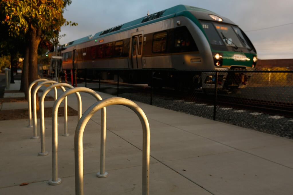 A SMART train passes by the new bicycle rack at the Railroad Square SMART rail station, in Santa Rosa. The trains are projected to be running in mid-2017. (Alvin Jornada / The Press Democrat)