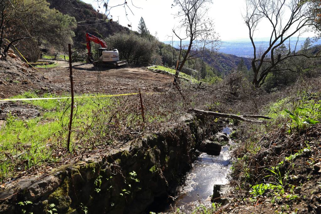 A small creek flows down past a lot that has been cleared of fire debris, off of Cavedale Road, near Glen Ellen on Tuesday, February 13, 2018. (Christopher Chung/ The Press Democrat)