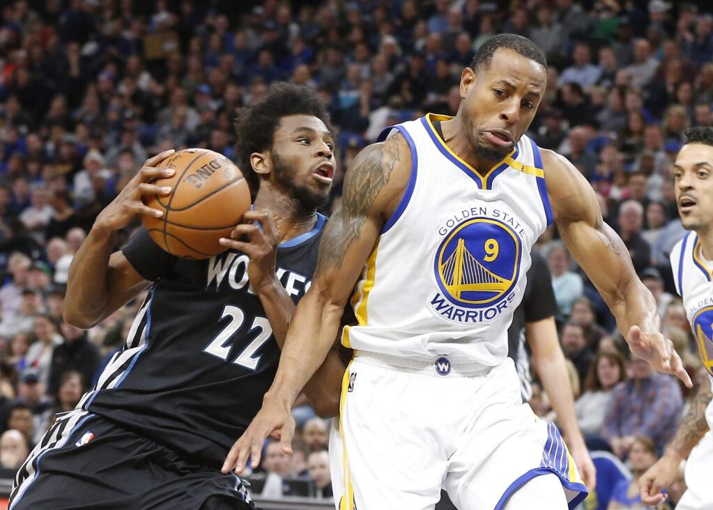 Minnesota Timberwolves' Andrew Wiggins, left, bumps into Golden State Warriors' Andre Iguodala as he drives during the first half of an NBA basketball game Friday, March 10, 2017, in Minneapolis. (AP Photo/Jim Mone)
