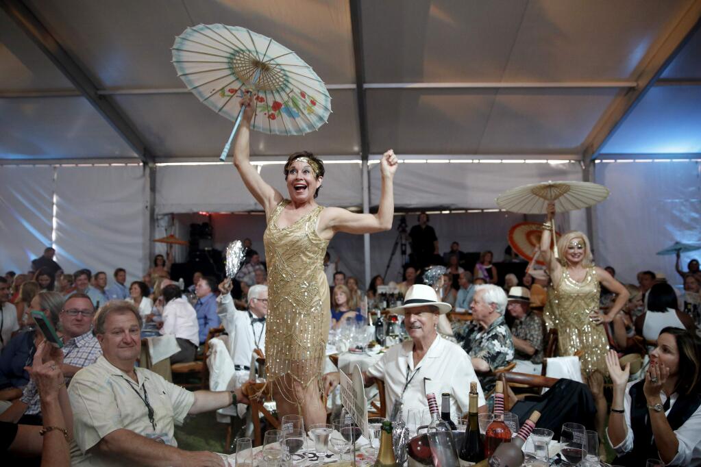 Suzy Fridell, left, and Chandra Friese, right, perform with Magnum Force during the Sonoma Harvest Wine Auction at Chateau St. Jean in 2015 . (BETH SCHLANKER/ The Press Democrat)