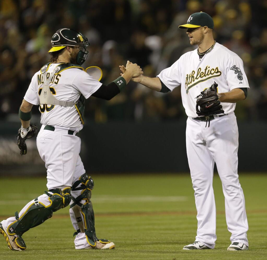 Oakland Athletics' Jon Lester, right, celebrates with catcher Derek Norris after the A's 3-0 win over the Minnesota Twins in a baseball game Thursday, Aug. 7, 2014, in Oakland. (AP Photo/Ben Margot)