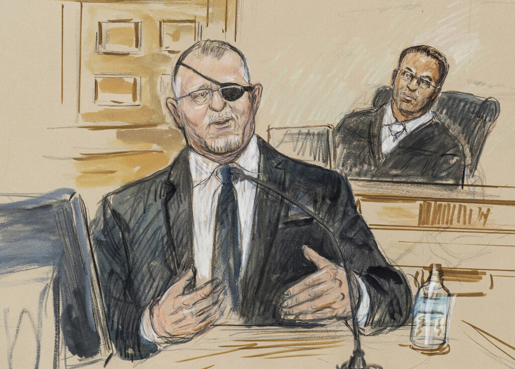FILE - This artist sketch depicts the trial of Oath Keepers leader Stewart Rhodes, left, as he testifies before U.S. District Judge Amit Mehta on charges of seditious conspiracy in the Jan. 6, 2021, attack on the U.S. Capitol, in Washington, Nov. 7, 2022. Rhodes has been sentenced to 18 years in prison for seditious conspiracy in the Jan. 6, 2021, attack on the U.S. Capitol. He was sentenced Thursday after a landmark verdict convicting him of spearheading a weekslong plot to keep former President Donald Trump in power. (Dana Verkouteren via AP, File)