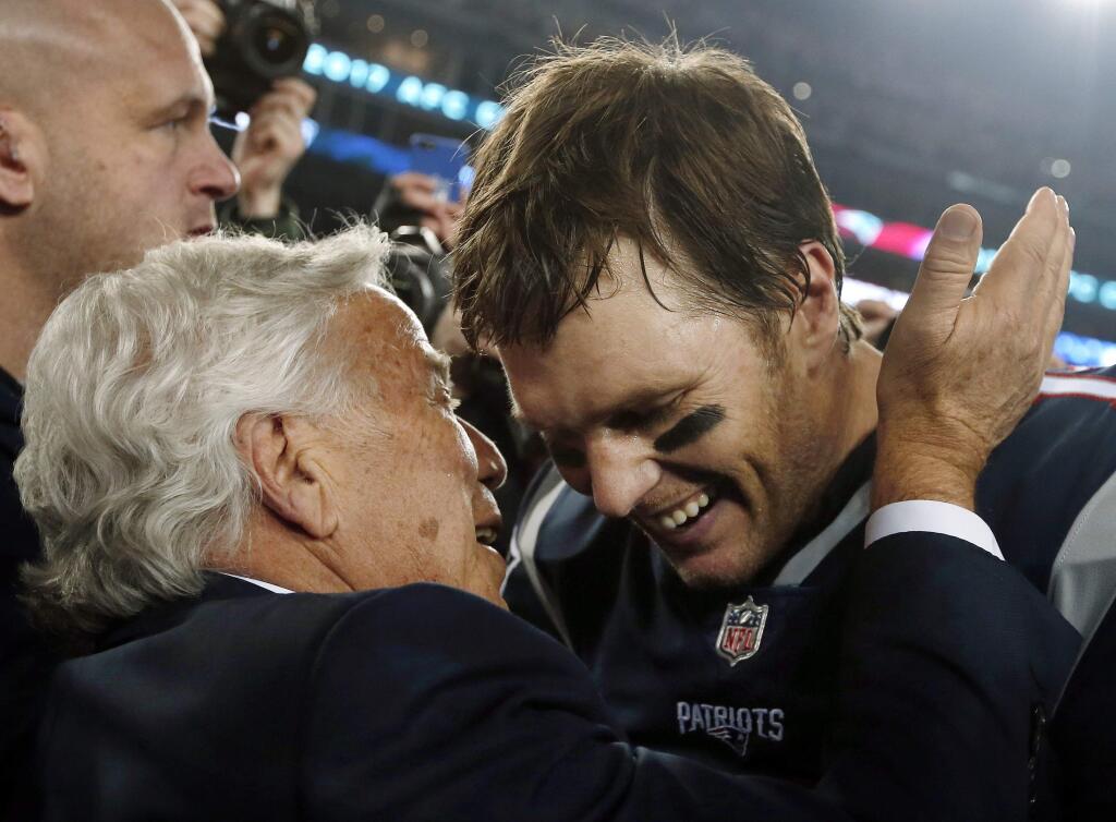 New England Patriots owner Robert Kraft, left, embraces quarterback Tom Brady after defeating the Jacksonville Jaguars in the AFC championship game, Sunday, Jan. 21, 2018, in Foxborough, Mass. The Patriots won 24-20. (AP Photo/Winslow Townson)
