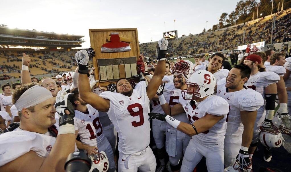 Stanford players including James Vaughters (9) run with the Stanford Axe after defeating California 38-17 after an NCAA college football game Saturday, Nov. 22, 2014, in Berkeley. (AP Photo/Ben Margot)