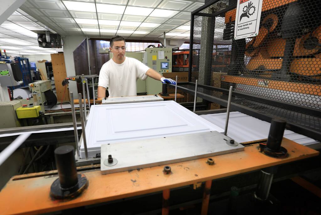 Jesus Morales of Empire West, a ceiling tile manufacturer in Graton, prepares to package plastic ceiling tiles, Tuesday Aug. 24, 2014. The company will stay in Sonoma County because PG&E is offering lower rates in order to retain businesses. The ceiling tile company will use more than $100,000 in electricity per year. (Kent Porter / Press Democrat) 2014