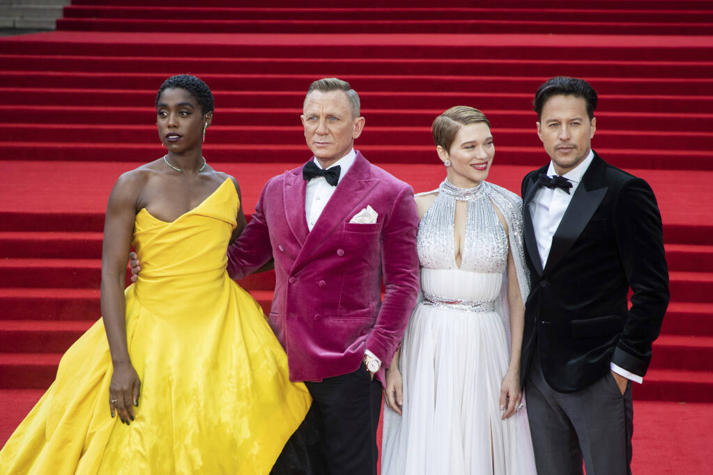 Lashana Lynch, from left, Daniel Craig, Lea Seydoux and Cary Joji Fukunaga pose for photographers upon arrival for the World premiere of the film “No Time To Die,” in London Tuesday, Sept. 28, 2021. (Photo by Vianney Le Caer/Invision/AP)