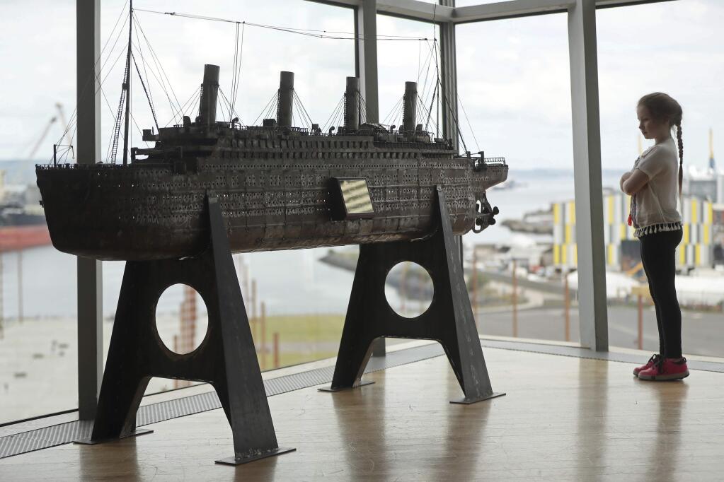 Aoise Taggert, 9, looks at a model of the Titanic at Titanic Belfast, Northern Ireland, Tuesday, July 24, 2018, during the launch of a bid to buy a collection of 5,500 artifacts from the Titanic wreck site and bring them to Belfast. (Niall Carson/PA Wire(/PA via AP)