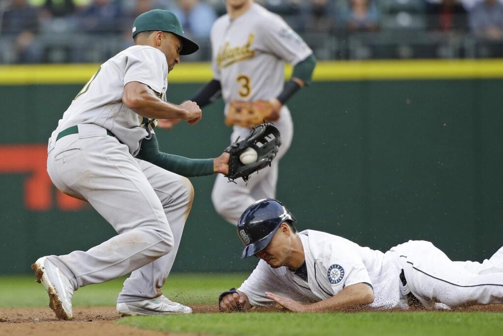 Seattle Mariners' Norichika Aoki is tagged out by Oakland Athletics shortstop Marcus Semien as he tries to steal second base during the second inning of a baseball game, Tuesday, May 24, 2016, in Seattle. (AP Photo/Ted S. Warren)