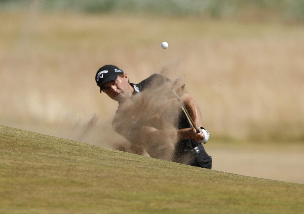 Kevin Kisner of the U.S. plays out of the bunker on the 17th hole during the first round of the British Open Golf Championship in Carnoustie, Scotland, Thursday, July 19, 2018. (AP Photo/Alastair Grant)