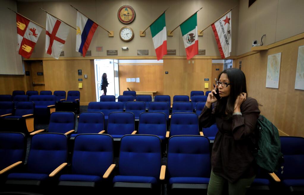 Dr. Celeste Philip, Health Officer for Sonoma County, stays late after the Sonoma County Board of Supervisors ratified a local state of emergency due to the Covid-19, to answer a phone call about the novel coronavirus, Wednesday, March 4, 2020 in Santa Rosa. (Kent Porter / The Press Democrat) 2020