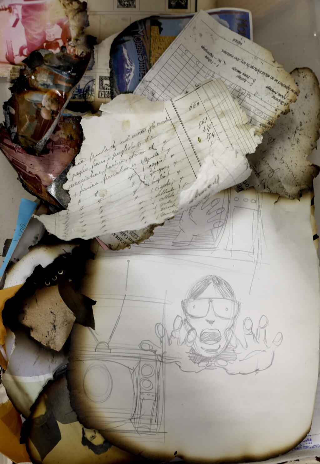 Photographs and papers damaged by the recent fires have been found and sent to Donald Laird, chair of the computer studies department, and his son, Sutter, who are collecting them and working to reunite them with their owners. Photo taken in his classroom at the Santa Rosa Junior College in Santa Rosa, on Sunday, October 29, 2017. (BETH SCHLANKER/ The Press Democrat)