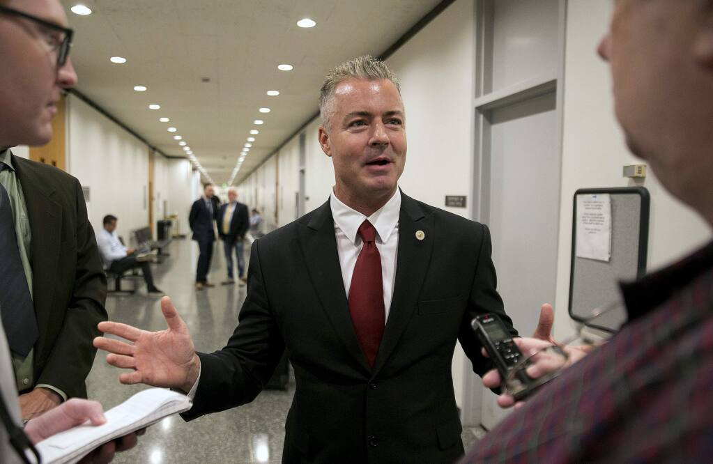 FILE - In this Sept. 22, 2017 file photo, Republican gubernatorial candidate Assemblyman Travis Allen, R-Huntington Beach, discusses a judge's ruling in Sacramento, Calif. Lt. Gov. Gavin Newsom has far outraised his rivals in the race for California governor ahead of the June 5 primary. Campaign finance reports filed this week show Newsom had nearly $17 million in the bank at the end of last year, more than all his rivals from both parties combined. San Diego businessman John Cox led the Republicans with just under $2 million in the bank. Assemblyman Travis Allen was in debt, with $136,000 in cash and more than $340,000 in unpaid bills. (AP Photo/Rich Pedroncelli, File)