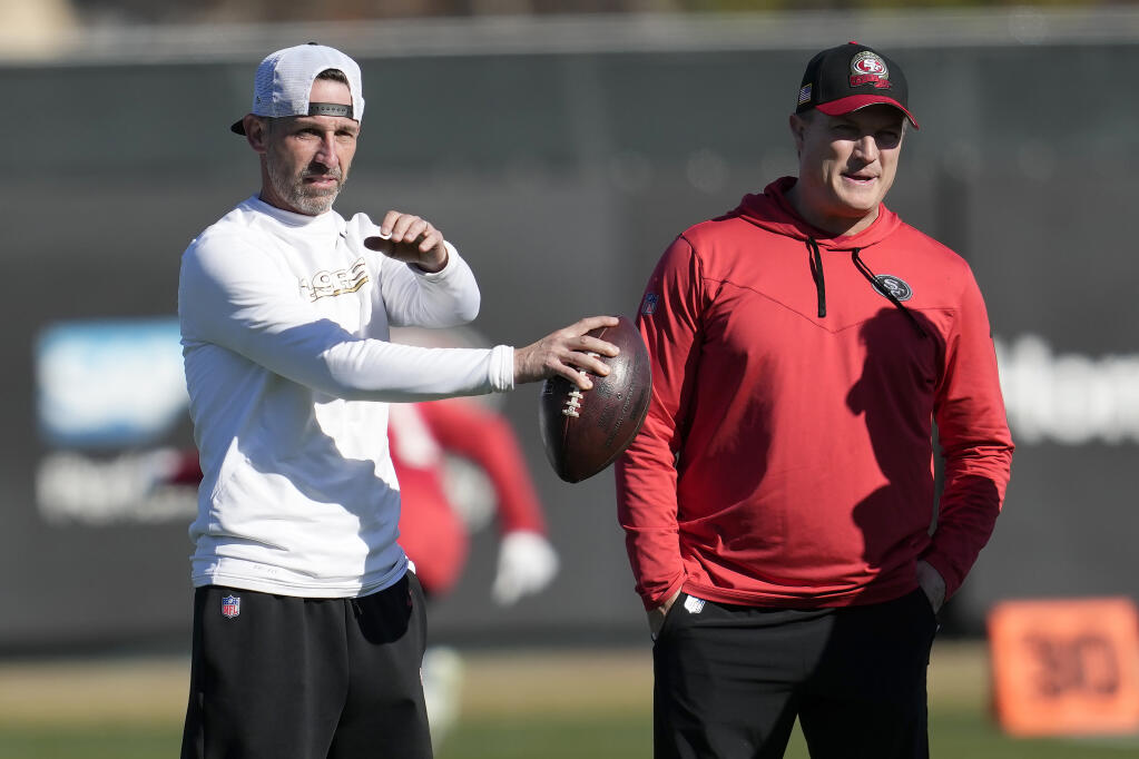 49ers head coach Kyle Shanahan, left, and general manager John Lynch watch as players take part in drills during practice Thursday in Santa Clara. (Jeff Chiu / ASSOCIATED PRESS)