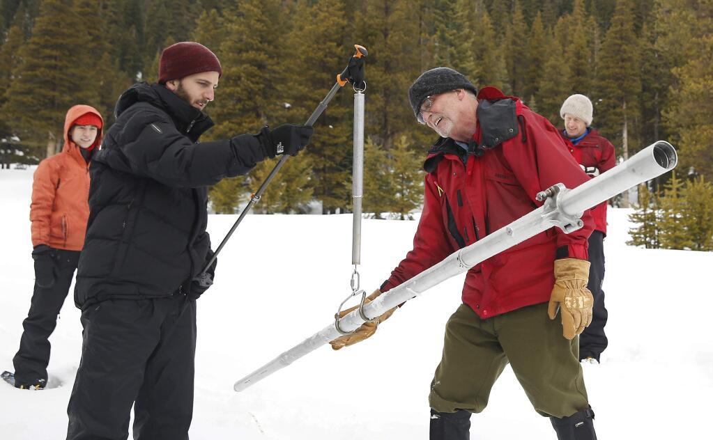 Frank Gehrke, right, chief of the California Cooperative Snow Surveys Program for the Department of Water Resources, checks the weight of the snow sample on a scale held by Mikel Shybut, a policy fellow with the California Council on Science and Technology, during the second manual snow survey of the season at at Phillips Station Thursday, Feb. 2, 2017, near Echo Summit, Calif. (AP Photo/Rich Pedroncelli)