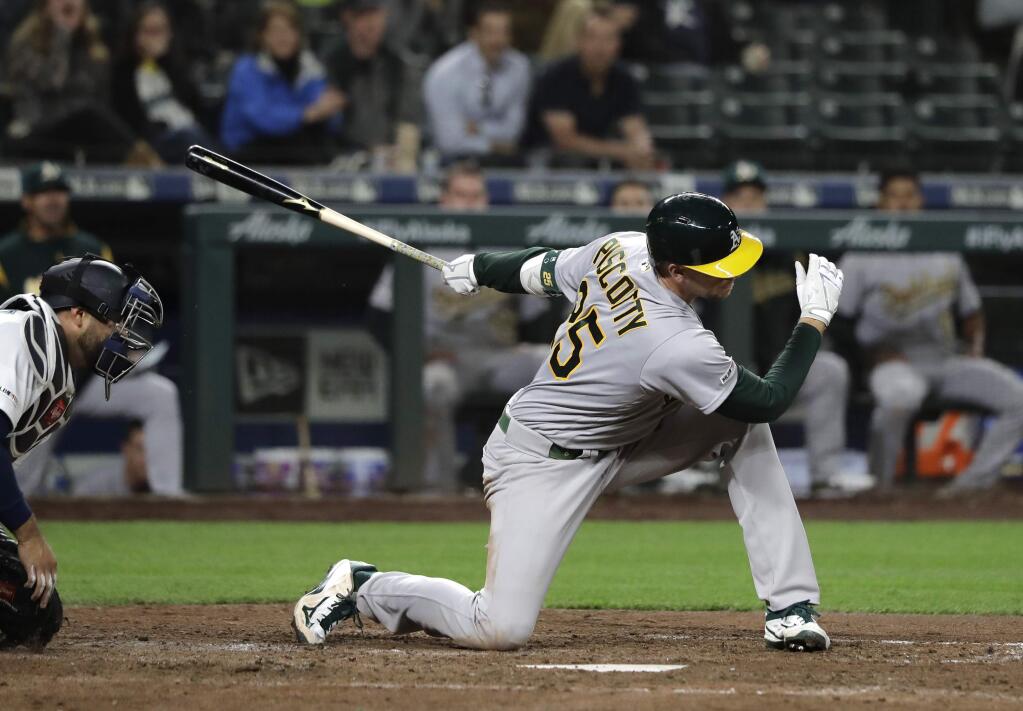 Oakland Athletics' Stephen Piscotty strikes out swinging with the bases load to end the top of the ninth inning of a baseball game against the Seattle Mariners, Monday, May 13, 2019, in Seattle. (AP Photo/Ted S. Warren)