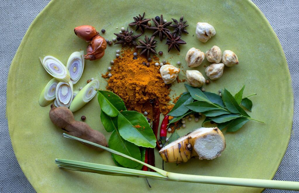 John Burgess / The Press Democrat)Chef/instructor Mei Ibach's Malaysian Rempah spice paste includes, clockwise from top, star anise, candlenuts, curry leaves, galangal, Thai chilies, kaffir lime leaves, tamarind, lemongrass, shallots and, in center, curry powder and peppercorns.
