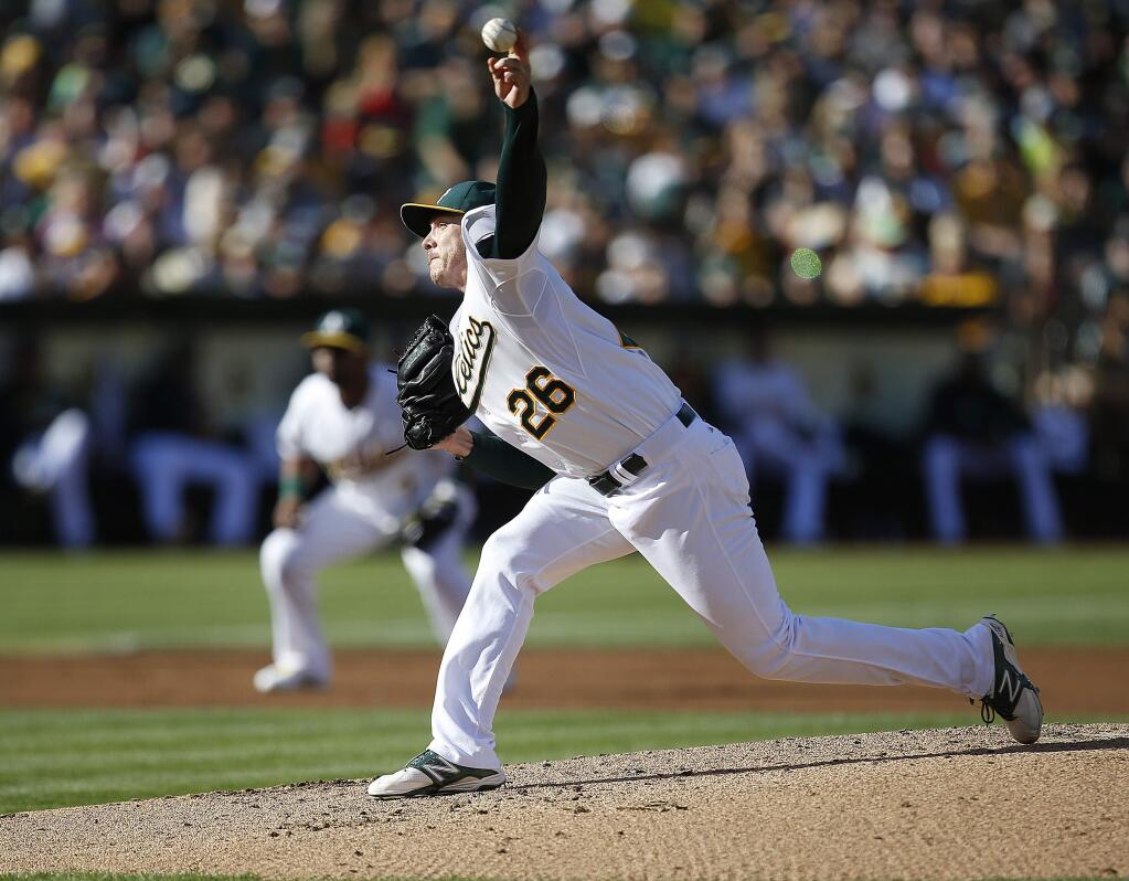 Oakland Athletics starting pitcher Scott Kazmir (26) works against the Los Angeles Angels in the second inning of a baseball game Sunday, Aug. 24, 2014, in Oakland, Calif. (AP Photo/Tony Avelar)
