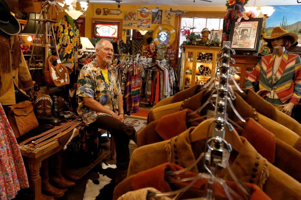 Lonesome Cowboy Ranch frontman Robert Barnhart sits among the variety western, Native American, and Hawaiian clothing and accessories for sale at Lonesome Cowboy Ranch in Boyes Hot Springs, California, on Thursday, June 22, 2017. (Alvin Jornada / The Press Democrat)