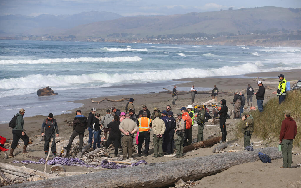 Salvage operation, California State Parks, and U.S. Coast Guard personnel meet after an effort to refloat the fishing vessel Aleutian Storm failed following the breaking of a haul line, along South Salmon Creek Beach, north of Bodega Bay, Monday, Feb. 12, 2024. (Christopher Chung / The Press Democrat)