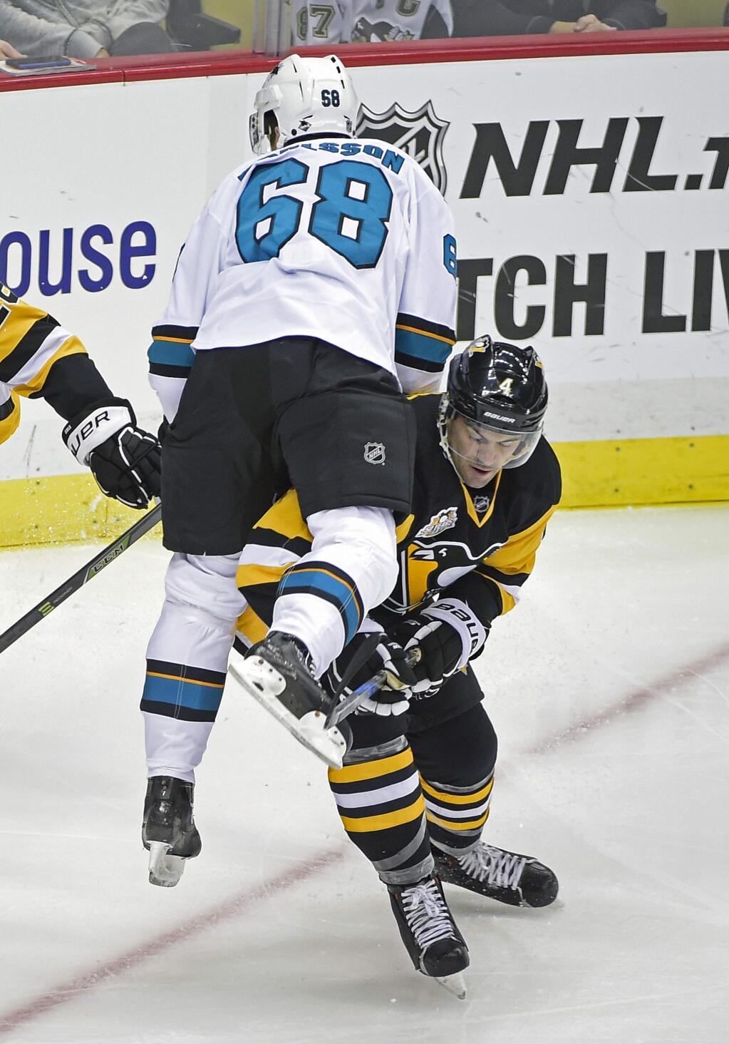 San Jose Sharks center Melker Karlsson (68) jumps onto the shoulders of Pittsburgh Penguins defenseman Justin Schultz (4) during the first period of an NHL hockey game on Thursday, Oct. 20, 2016, in Pittsburgh. (AP Photo/Fred Vuich)