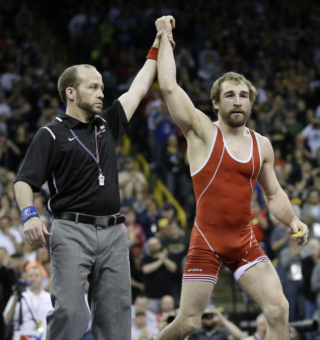 Daniel Dennis reacts after defeating Tony Ramos in their 57-kilogram freestyle finals match at the U.S. Olympic Wrestling Team Trials, Sunday, April 10, 2016, in Iowa City, Iowa. (AP Photo/Charlie Neibergall)