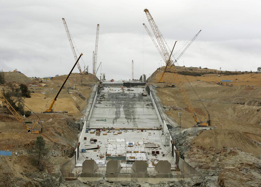 Work continues to repair the damaged main spillway of the Oroville Dam on Thursday, Oct. 19, 2017, in Oroville, Calif. California officials say repair costs at the nation's tallest dam will be nearly double the original estimate of $275 million. The main spillway and emergency spillway suffered significant damage during storms last February, prompting fears of massive flooding. (AP Photo/Rich Pedroncelli)