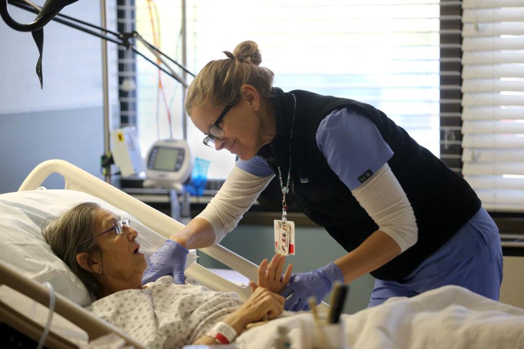 Shawn Spelman, R.N., treats patient Cathleen Diltz of Clearlake, California, who is recovering from a stroke at Sonoma Specialty Hospital in Sebastopol, California, on Tuesday, February 5, 2019. (BETH SCHLANKER/The Press Democrat)