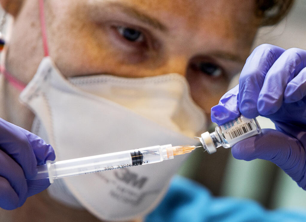 Dr. Clark Santee fills a syringe with the monkeypox vaccine clinic at the Russian River Health Center clinic targeting high-risk individuals attending Lazy Bear Week in Guerneville on Monday, Aug. 1, 2022. (John Burgess / The Press Democrat)